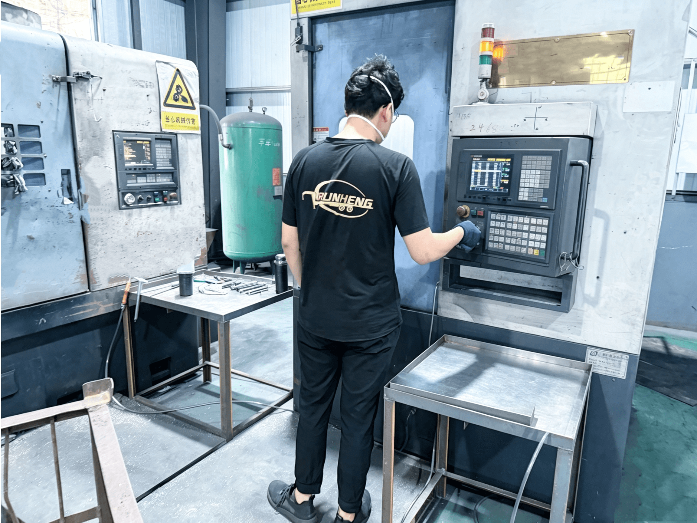 RUNHENG operator working at a CNC equipment control station
